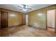 Spacious bedroom with hardwood floors, wood paneled walls, ceiling fan, and doorways at 109 Amberidge Nw Dr, Cartersville, GA 30121