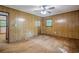 Bedroom featuring hardwood floors, wood paneled walls, ceiling fan, and a doorway at 109 Amberidge Nw Dr, Cartersville, GA 30121