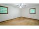 Bedroom featuring hardwood floors, white walls, two windows, and a ceiling fan at 109 Amberidge Nw Dr, Cartersville, GA 30121