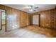 Wood-paneled bedroom featuring hardwood floors, ceiling fan, and doorways to other rooms at 109 Amberidge Nw Dr, Cartersville, GA 30121