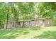Single-story home with a stone facade, front porch and lush green lawn with mature trees at 109 Amberidge Nw Dr, Cartersville, GA 30121