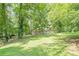 Single-story home with a front porch, stone facade and a lush green lawn with mature trees at 109 Amberidge Nw Dr, Cartersville, GA 30121