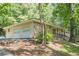 Single-story home with two car garage featuring a stone facade, front porch and lush greenery at 109 Amberidge Nw Dr, Cartersville, GA 30121