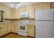 Well-lit kitchen featuring white appliances, cream cabinets, and durable countertops at 109 Amberidge Nw Dr, Cartersville, GA 30121