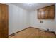 Bright laundry room with wood cabinets and flooring, plus hookups for washer and dryer at 109 Amberidge Nw Dr, Cartersville, GA 30121