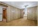 Spacious living room featuring wood paneling, hardwood floors, and an open doorway to the kitchen at 109 Amberidge Nw Dr, Cartersville, GA 30121