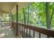 Covered front porch with wood railing overlooking a lush green lawn and mature trees at 109 Amberidge Nw Dr, Cartersville, GA 30121