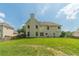 Sprawling backyard with a lush lawn, privacy fence and the rear elevation of a two-story home at 2479 Mitford Ct, Dacula, GA 30019