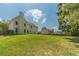 A vast backyard with a plush lawn, a privacy fence, and the back of the home with a blue sky at 2479 Mitford Ct, Dacula, GA 30019
