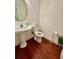 Bathroom with a pedestal sink, and hardwood floors at 2479 Mitford Ct, Dacula, GA 30019