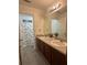 Bathroom with double sinks, granite countertops, and a shower with decorative curtain at 2479 Mitford Ct, Dacula, GA 30019