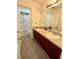 Bathroom featuring double sinks, granite countertop, a mirror, and a shower with a curtain at 2479 Mitford Ct, Dacula, GA 30019
