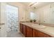 Bathroom with dual vanity, granite countertop, and a shower with patterned curtain at 2479 Mitford Ct, Dacula, GA 30019