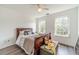 Cozy bedroom with natural light, laminate floors, and ceiling fan at 2479 Mitford Ct, Dacula, GA 30019