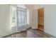 Bright bedroom with a large window, white walls, and a closet with wood laminate flooring at 2479 Mitford Ct, Dacula, GA 30019