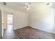 Spacious bedroom with modern floors, ceiling fan, and access to another room at 2479 Mitford Ct, Dacula, GA 30019