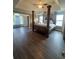 Spacious bedroom showcasing a four-poster bed, hardwood floors, and plenty of natural light at 2479 Mitford Ct, Dacula, GA 30019