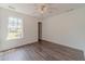 Bedroom with laminate floors, ceiling fan, and a bright window view at 2479 Mitford Ct, Dacula, GA 30019