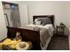 Bedroom features a nice bed, flooring, decor, and a tidy closet with open doors at 2479 Mitford Ct, Dacula, GA 30019