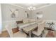 Elegant dining room with stylish chandelier, wainscoting, and neutral decor at 2479 Mitford Ct, Dacula, GA 30019
