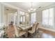Bright dining room with hardwood floors, a chandelier, and large windows dressed with decorative curtains at 2479 Mitford Ct, Dacula, GA 30019