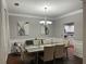 Dining room with elegant lighting, refined furnishings, and hardwood floors for comfortable dining at 2479 Mitford Ct, Dacula, GA 30019