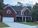 Charming brick two-story home with a well-manicured lawn and a two-car garage at 2479 Mitford Ct, Dacula, GA 30019