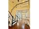Inviting foyer featuring hardwood floors, a staircase with dark accents, and views of the upper level at 2479 Mitford Ct, Dacula, GA 30019