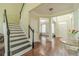 Spacious foyer with hardwood flooring, staircase, and views into other living areas at 2479 Mitford Ct, Dacula, GA 30019