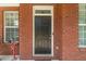 Welcoming front entrance with a classic black door and charming brick facade at 2479 Mitford Ct, Dacula, GA 30019