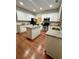 Kitchen features white cabinets, stainless steel appliances and granite countertops, with a convenient island at 2479 Mitford Ct, Dacula, GA 30019