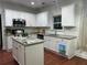 Bright kitchen with white cabinets, granite countertops, and stainless steel appliances at 2479 Mitford Ct, Dacula, GA 30019