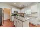 Bright kitchen showcases white cabinetry, granite countertops, stainless steel appliances, and a center island at 2479 Mitford Ct, Dacula, GA 30019