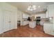 Spacious kitchen features white cabinets, stainless steel appliances, granite countertops and a central island at 2479 Mitford Ct, Dacula, GA 30019