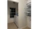 Well lit laundry room features modern washer and dryer with plenty of shelving for storage at 2479 Mitford Ct, Dacula, GA 30019