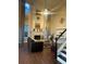 Elegant living room with fireplace, tall windows, hardwood floors, and a comfortable seating area at 2479 Mitford Ct, Dacula, GA 30019