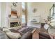 Inviting living room featuring a fireplace, hardwood floors, and high ceilings at 2479 Mitford Ct, Dacula, GA 30019
