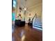 Living room with hardwood floors, a staircase, a fireplace, and two story windows at 2479 Mitford Ct, Dacula, GA 30019