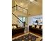 Open floor plan with a two story foyer, a staircase with black trim, and hardwood floors at 2479 Mitford Ct, Dacula, GA 30019