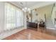 Open concept living room with a high ceiling, hardwood floors, and a cozy seating area with a television at 2479 Mitford Ct, Dacula, GA 30019