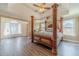 Main bedroom with a four-poster bed, tray ceiling, and bright windows at 2479 Mitford Ct, Dacula, GA 30019