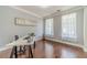 Home office featuring hardwood floors, neutral walls, and ample natural light at 2479 Mitford Ct, Dacula, GA 30019