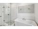 Bright bathroom featuring white subway tile, glass shower, and freestanding tub with modern fixtures at 522 Hargrove Ln, Decatur, GA 30030