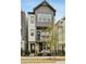 Charming three-story home features a black metal fence, balcony, and a combination of siding and brick at 522 Hargrove Ln, Decatur, GA 30030