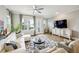 Bright living room features modern ceiling fan, hardwood flooring, and ample sunlight at 522 Hargrove Ln, Decatur, GA 30030