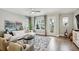 Elegant living room with gray accents, hardwood floors, and sliding glass door to balcony at 522 Hargrove Ln, Decatur, GA 30030