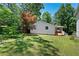 Well-maintained backyard with mature trees and lush green grass, providing a serene outdoor space at 5971 Dogwood Se Dr, Acworth, GA 30102