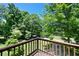 A tranquil balcony view surrounded by a verdant landscape and mature trees, offering a serene outdoor experience at 5971 Dogwood Se Dr, Acworth, GA 30102