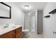 Cozy bathroom features a shower with glass doors, framed mirror, and a wood vanity with chrome faucet at 5971 Dogwood Se Dr, Acworth, GA 30102