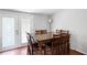 Dining room with hardwood floors, a large wooden table, and access to the outdoor patio at 5971 Dogwood Se Dr, Acworth, GA 30102
